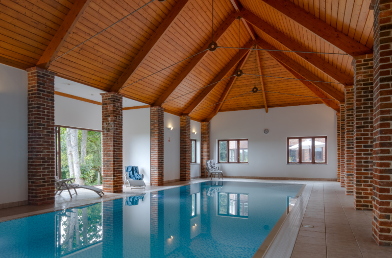 indoor swimming pool with wooden pitched ceiling